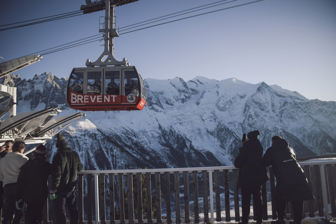 A group of people standing next to a ski lift