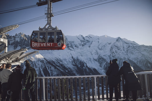 A group of people standing next to a ski lift