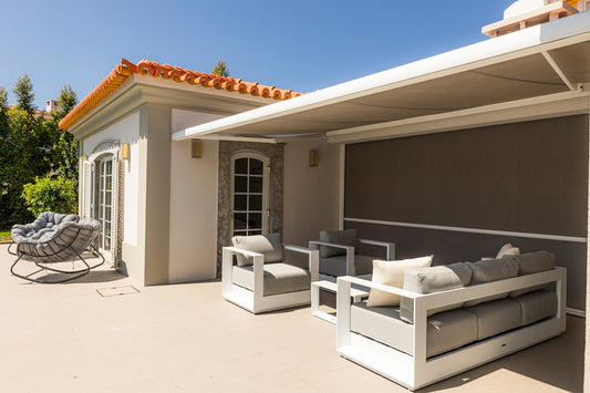 Outdoor patio with stylish seating and awning.