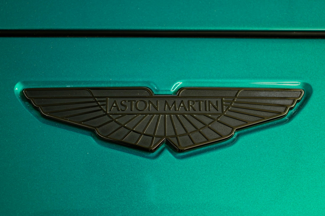 An aston martin logo on teal paint