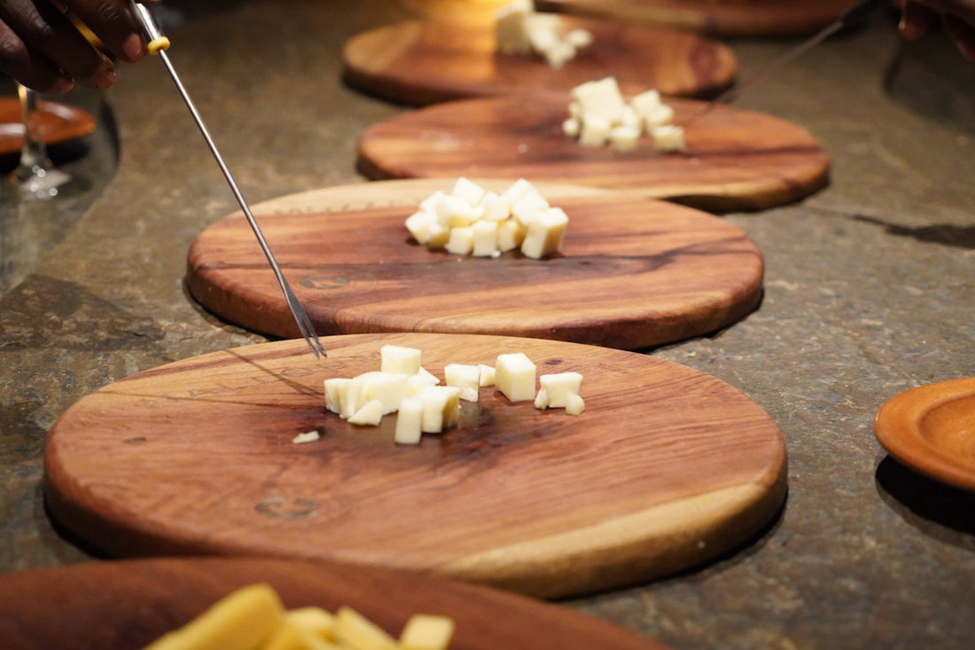 People dipping cheese into fondue pots